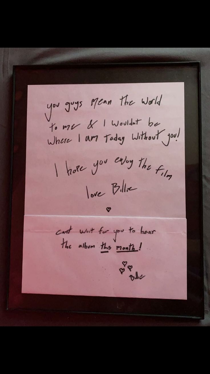 a pink piece of paper with writing on it