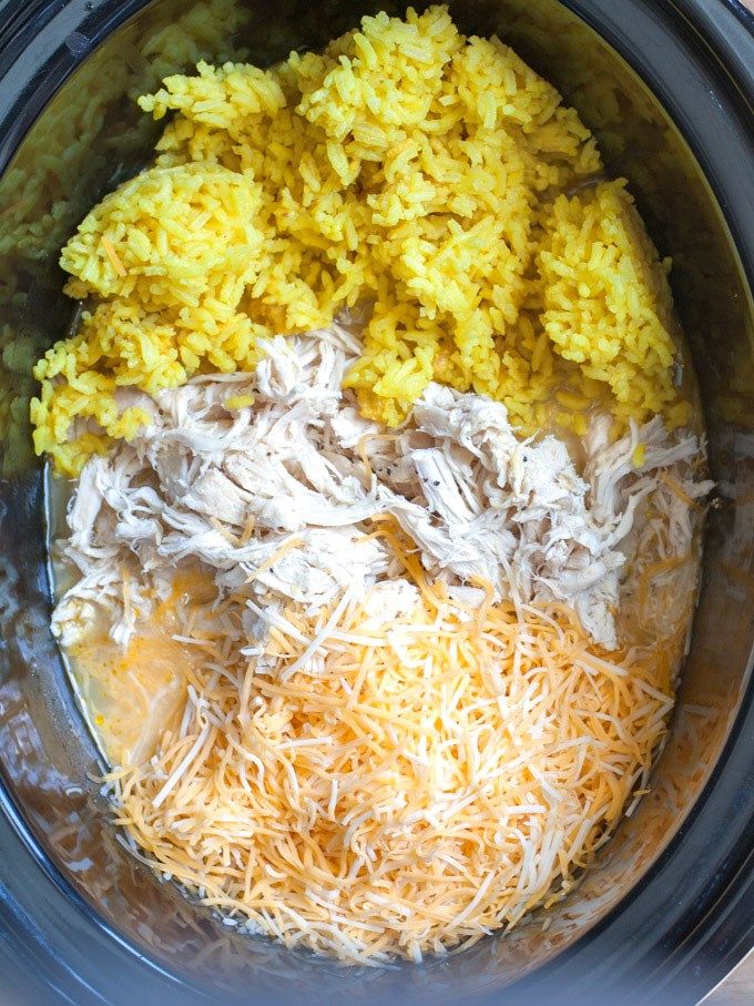 rice and other ingredients are mixed in the crock pot to make an entree