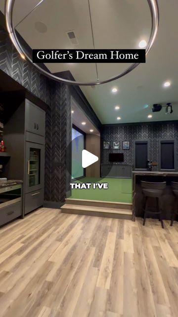 the inside of a home with wood floors and green walls, an open kitchen area