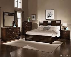 a large bed sitting in a bedroom next to a dresser with drawers and mirror on top of it