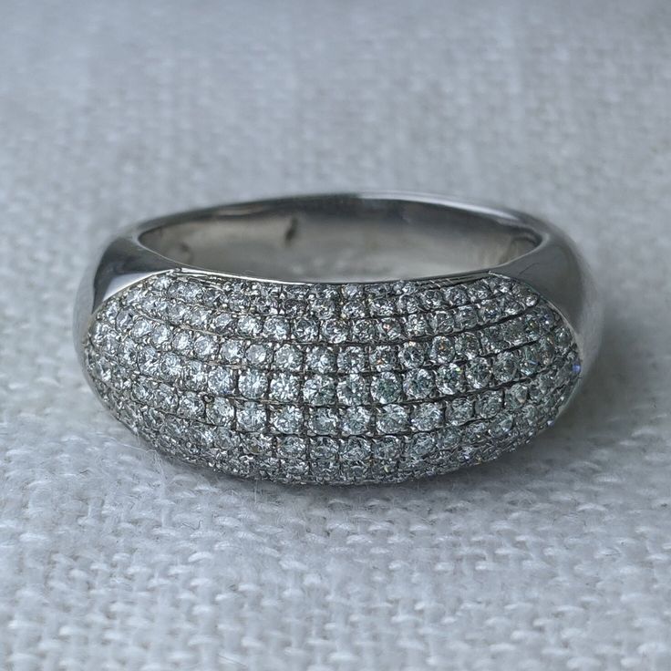 This late-century estate statement ring is crafted in 14k white gold. The modern dome ring sparkles with 177 full-cut diamonds weighing approximately 1.80cttw (average grade G-H color/SI clarity). The micro-pave effect is stunning when it catches the light and worthy of a black tie event. However, the minimalist design is simple enough for a Saturday morning brunch. * 14k white gold * 1.80cttw diamond (G-H/SI) * Current ring size is a 8.5 and due to the micro-pave diamonds we recommend it should Luxury Platinum Dome Ring For Formal Occasions, Luxury White Dome Ring For Anniversary, Luxury Formal Dome Ring With Pave Setting, Luxury White Dome Ring With Open Design, Luxury Classic Domed Diamond Ring, Luxury Domed Rings With Diamond Accents, Silver Dome Ring With Diamond Pave Setting, Luxury Domed White Gold Diamond Ring, Luxury Dome Ring With Pave Setting Fine Jewelry