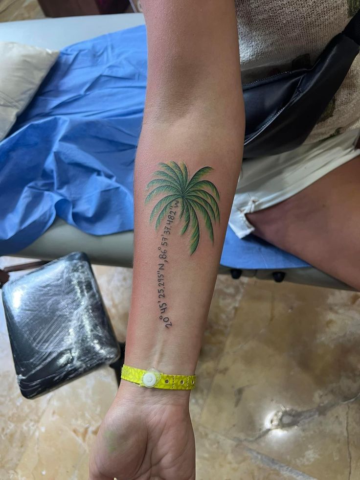 a person with a palm tree tattoo on their arm and the words, i love you