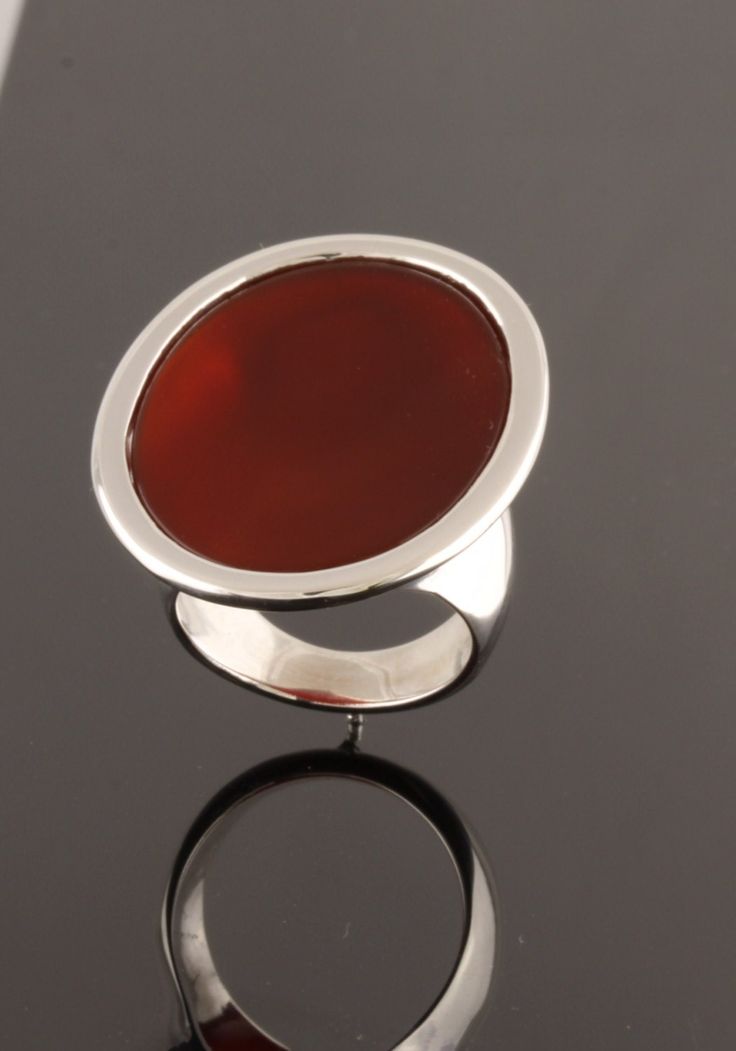 30x22mm oval flat top carnelian set in sterling silver ring.  Available with any type of gemstone. *Cabochon *Flat *Buff top *Rose cut ( depending on availability)  This ring is high polished and is also available with textured surface. Please indicate your ring size. Also available in gold.  Price in 14kt white or yellow gold $1050.00 Modern Oval Cabochon Signet Ring, Formal Carnelian Oval Signet Ring, Formal Oval Carnelian Signet Ring, Elegant Carnelian Rings With Polished Finish, Modern Carnelian Jewelry With Polished Finish, Modern Oval Cabochon Signet Ring As Gift, Modern Oval Cabochon Signet Ring For Gift, Carnelian Signet Ring With Polished Finish, Elegant Carnelian Oval Cabochon Ring