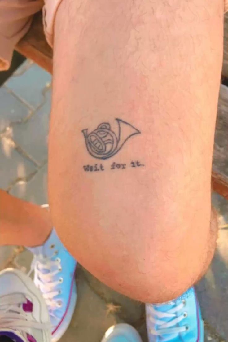 a person with a small tattoo on their leg that reads, well for all and