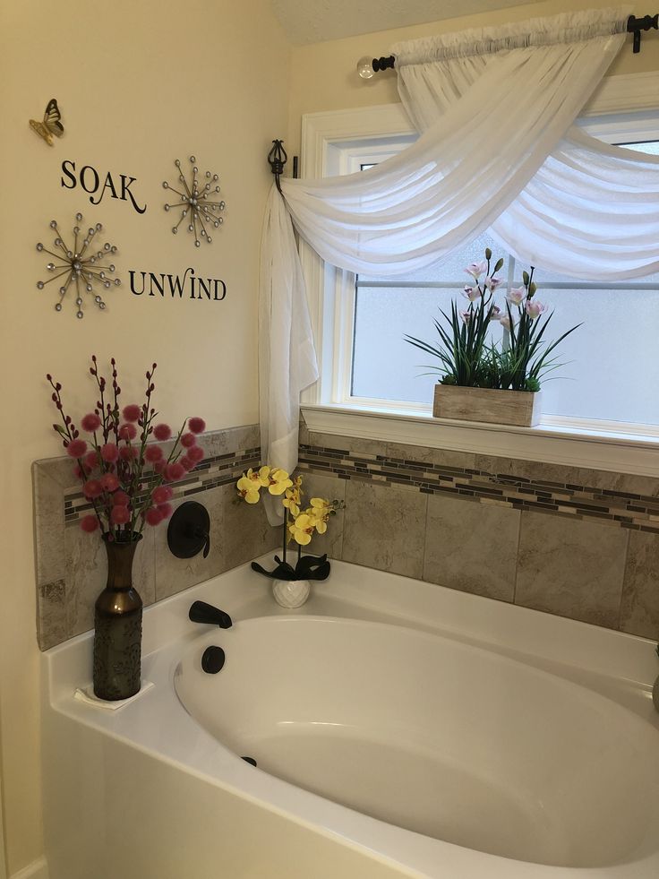 a bath tub with flowers in the corner