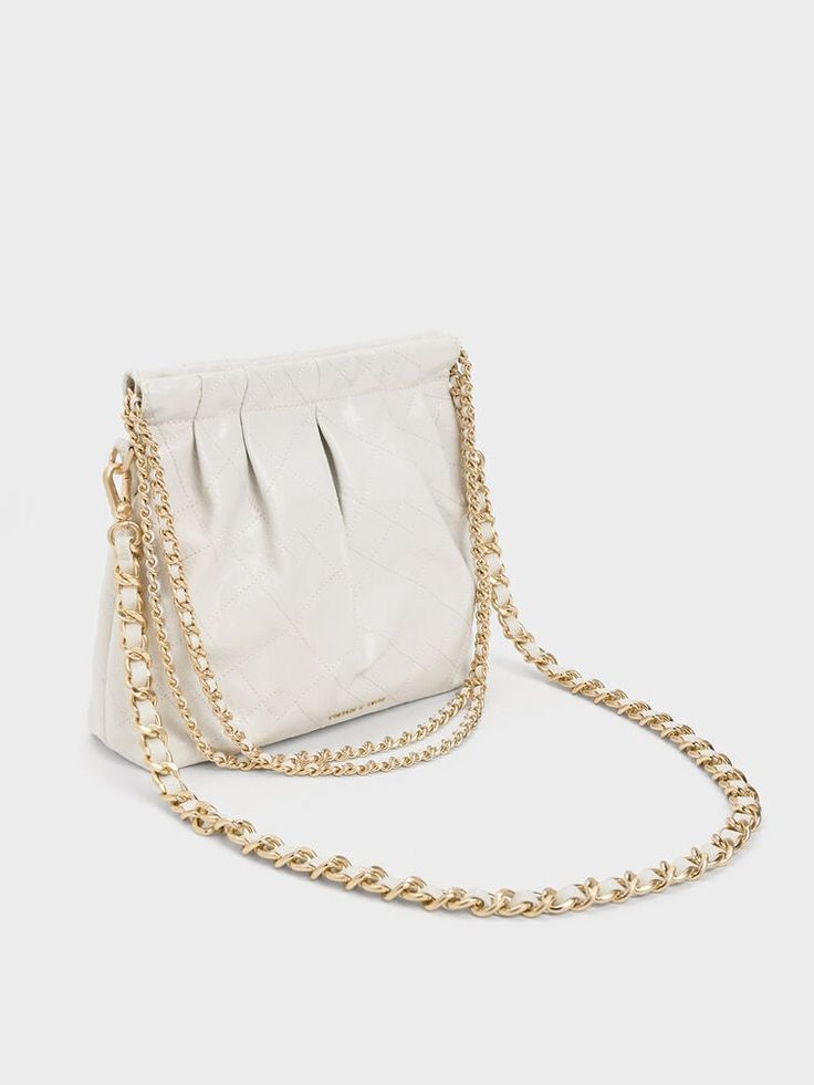 In classic white for maximum style mileage, this match-all version of our Duo shoulder bag is one you will want to wear on repeat. Featuring a seamless magnetic closure that opens up into a roomy interior, this bag is perfectly sized to keep all your daily essentials and then some. With a high-shine gold-tone double chain handle and hardware for added polish, it is the perfect piece to complement off-duty outfits and chic ensembles alike. Off Duty Outfits, Charles Keith, Platform Ankle Boots, Double Chain, On Repeat, Off Duty, White Bag, Classic White, Magnetic Closure