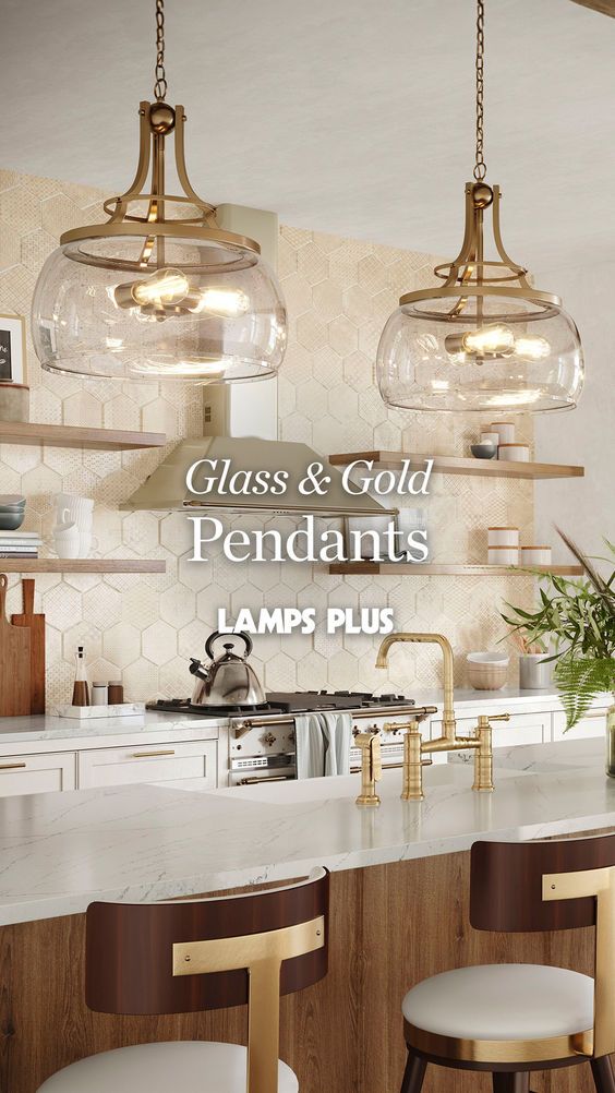 the glass and gold pendant lights are hanging over the kitchen island