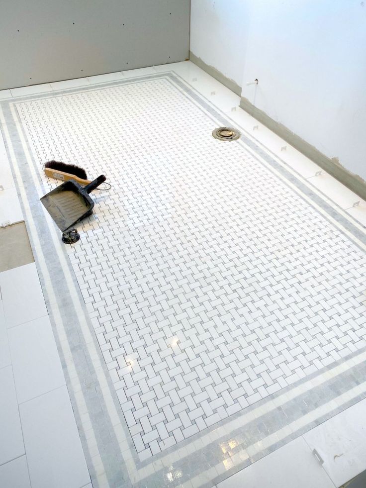 a bathroom floor with tools laying on it