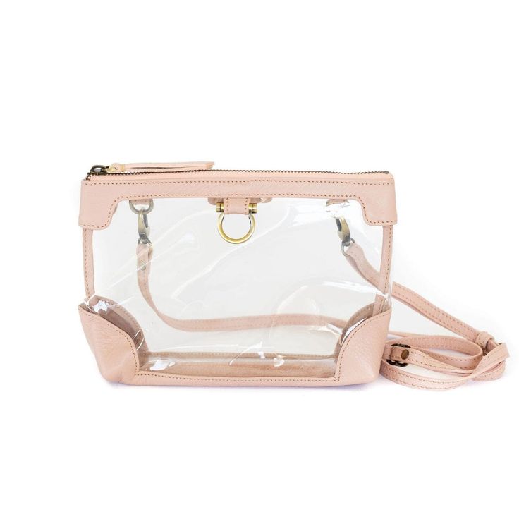 With a multi-purpose design, our Sharon Clear Crossbody is an essential. This clear bag has endless uses—as a clear bag for stadiums, or remove the strap and use for makeup , toiletries, diaper bag essentials, or as a storage option inside larger handbags, totes, duffle bags and suitcases. Need something smaller? Look at our Sharon Mini Clear Crossbody! Features Beautiful leather trim: Our buttery soft leather trims the bag in colors you’ll want to keep packing. ﻿Removable strap: ﻿Use the includ Clear Satchel Bag For Travel, Daily Use Crossbody Bag With Clear Strap, Clear Strap Crossbody Shoulder Bag, Crossbody Shoulder Bag With Clear Strap, Clear Rectangular Bag With Detachable Strap, Clear Rectangular Bag With Removable Pouch, Clear Shoulder Bag With Removable Pouch, Clear Shoulder Bag With Transparent Straps, Clear Crossbody Bag With Adjustable Strap