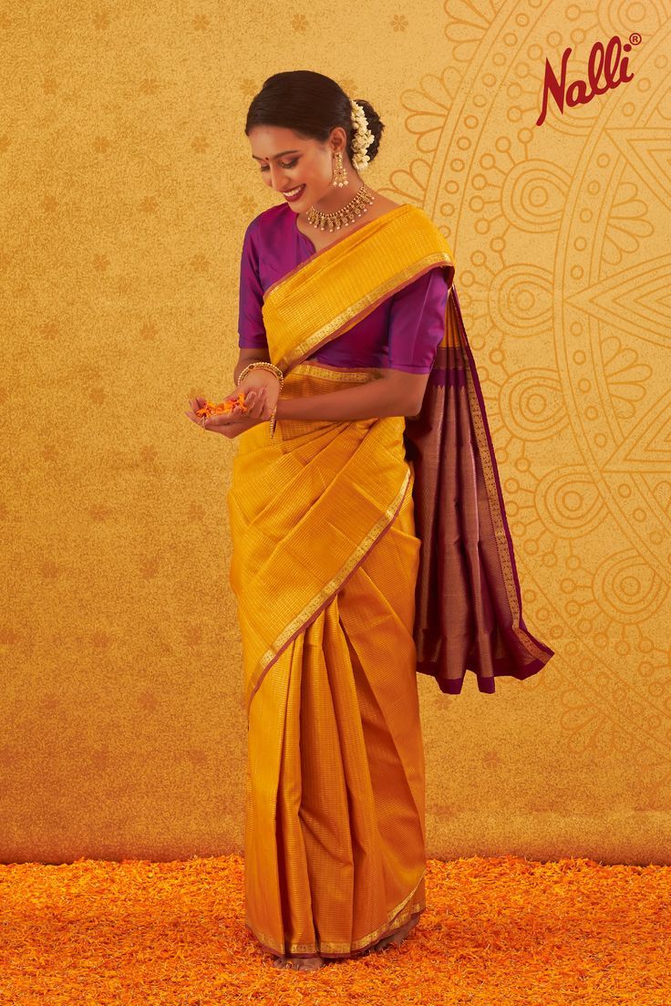 Saree Drape Look: This beautiful saree is draped in a statement style with spread waist front pleats followed by wrapping the pleated pallu side around and pinned on the shoulders neatly for an elegant touch. Blouse Styling: Saree is paired with a contrast fitted blouse in a v-neck pattern to finish the look. Accessories: Saree styling is paired with a stoned neckpiece, earrings, and a neatly done head bun with floral detail. Front Pallu Saree, Front Pallu Saree Draping, Head Bun, Styling Saree, Blouse Styling, Draping Pattern, Nalli Silks, Saree Styling, Saree Drape