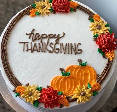 a decorated cake with the words happy thanksgiving written in frosting and flowers around it