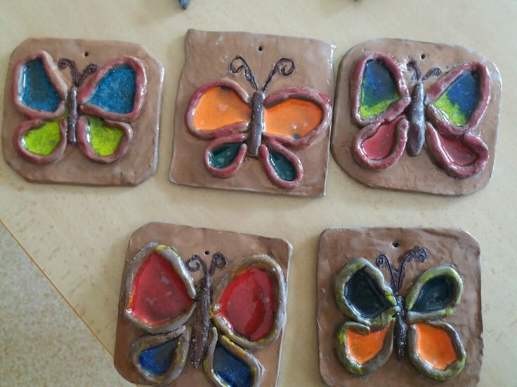 four butterfly shaped cookies sitting on top of a table