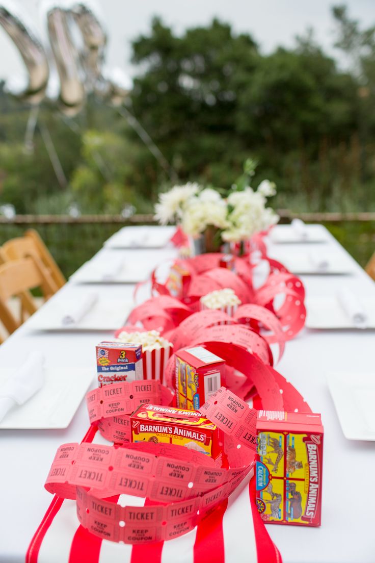 a long table is decorated with red ribbons and candy bar wrappers for valentine's day