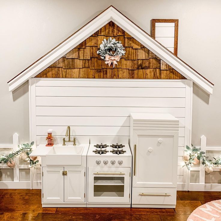 a white stove top oven sitting inside of a kitchen next to a wall mounted clock