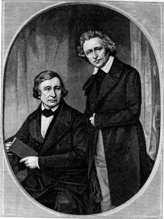 an old black and white photo of two men in formal attire, one with his arm around the other's shoulder