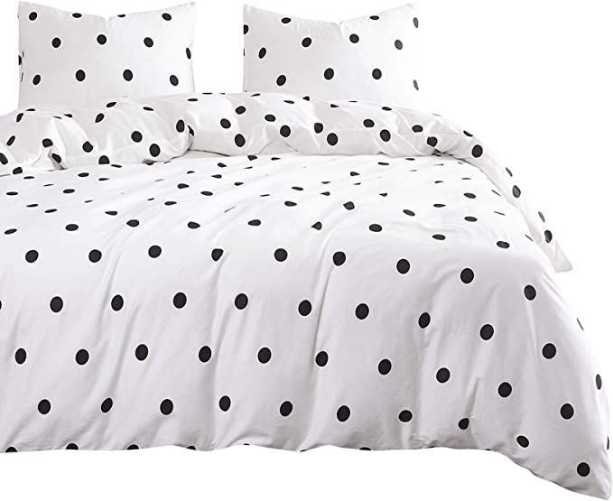 a bed with black and white polka dots on it