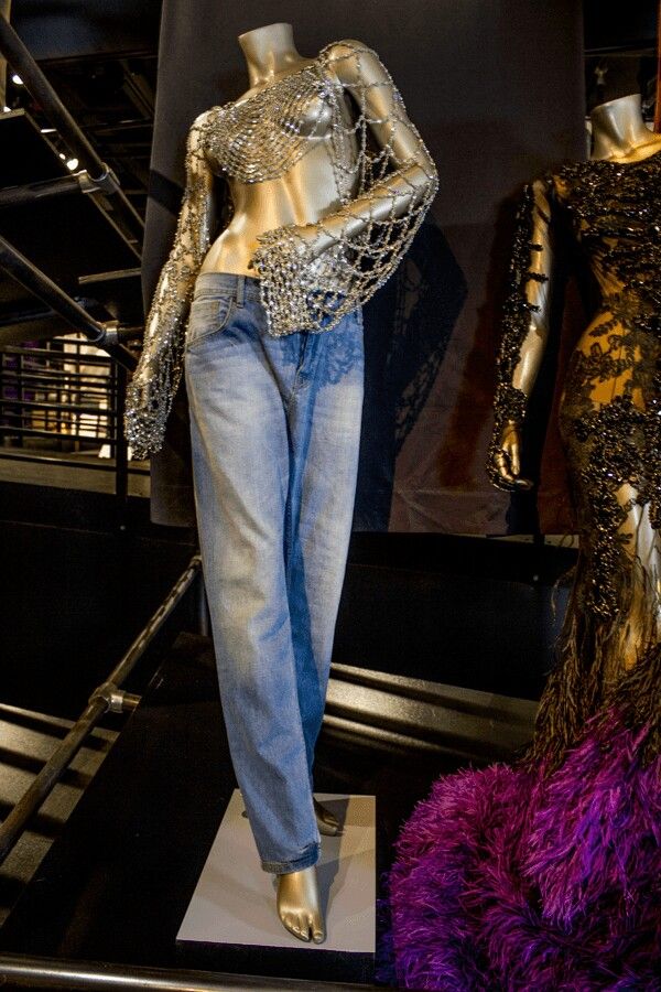 two mannequins dressed in jeans and sequins on display next to each other