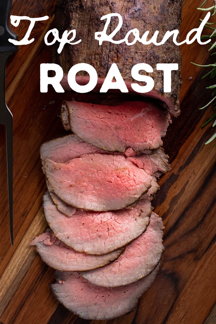 sliced roast beef sitting on top of a cutting board next to a knife and rosemary sprig