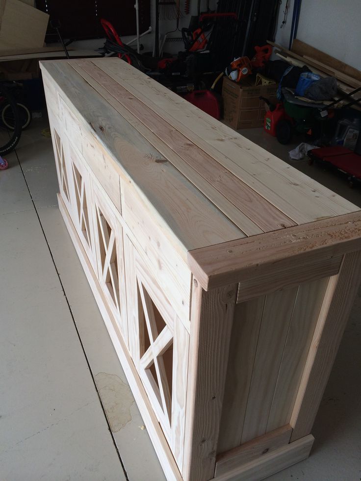 a large wooden cabinet sitting on top of a hard wood floor