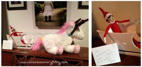 an elf is sitting on top of a stuffed animal and another has a note attached to it