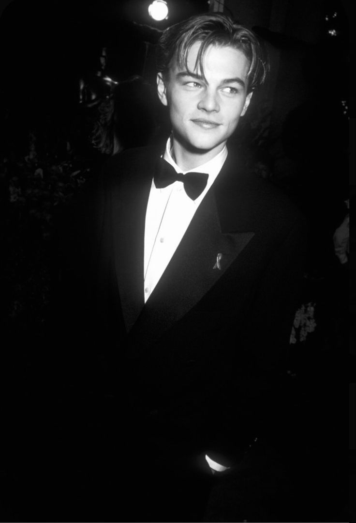 a black and white photo of a man in a tuxedo