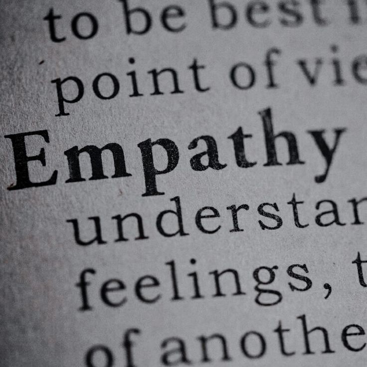 an open book with the word empathy written in black and white on it