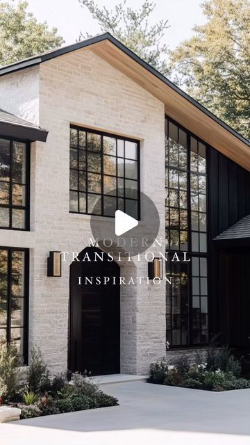 a white brick house with black trim and windows