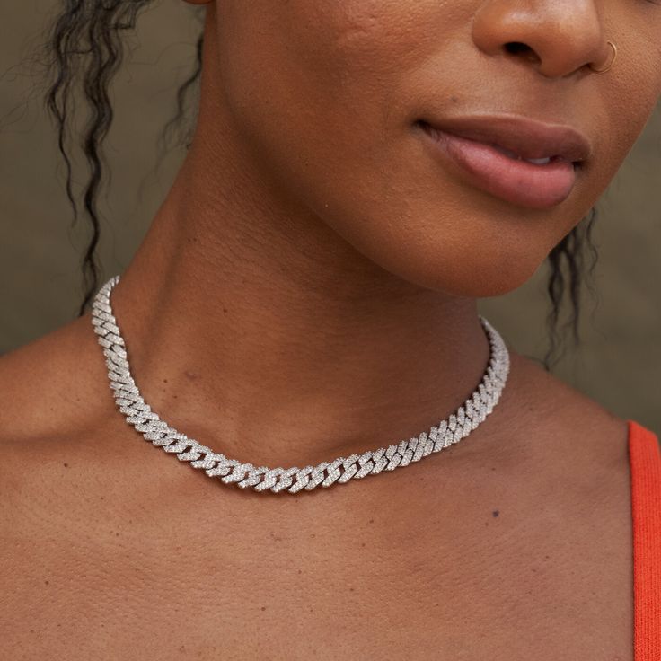 Introducing our 8.5mm Diamond Prong Cuban Necklace, a white gold plated necklace featuring prong links covered in clear stones connecting the full piece. This chain is the perfect size, the middle ground between micro prong and the larger 12mm prong necklace. Paired with the classic 8.5mm Prong Link Bracelet, they make a fabulous fashion set for nights out. This product is guaranteed for life - GLD will repair the item should you experience any defects in craftsmanship or breakage. Specification White Diamond Cuban Link Necklace, Diamond White Cuban Link Necklace, Luxury Diamond White Cuban Link Necklace, Diamond-cut Cuban Link Diamond Necklace, Gold Diamond-cut Cuban Link Necklace Gift, Brand Stickers, Clear Stone, Gold Plated Necklace, Gold Plated Chains