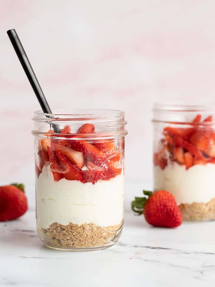 no bake strawberry cheesecake in a jar with strawberries