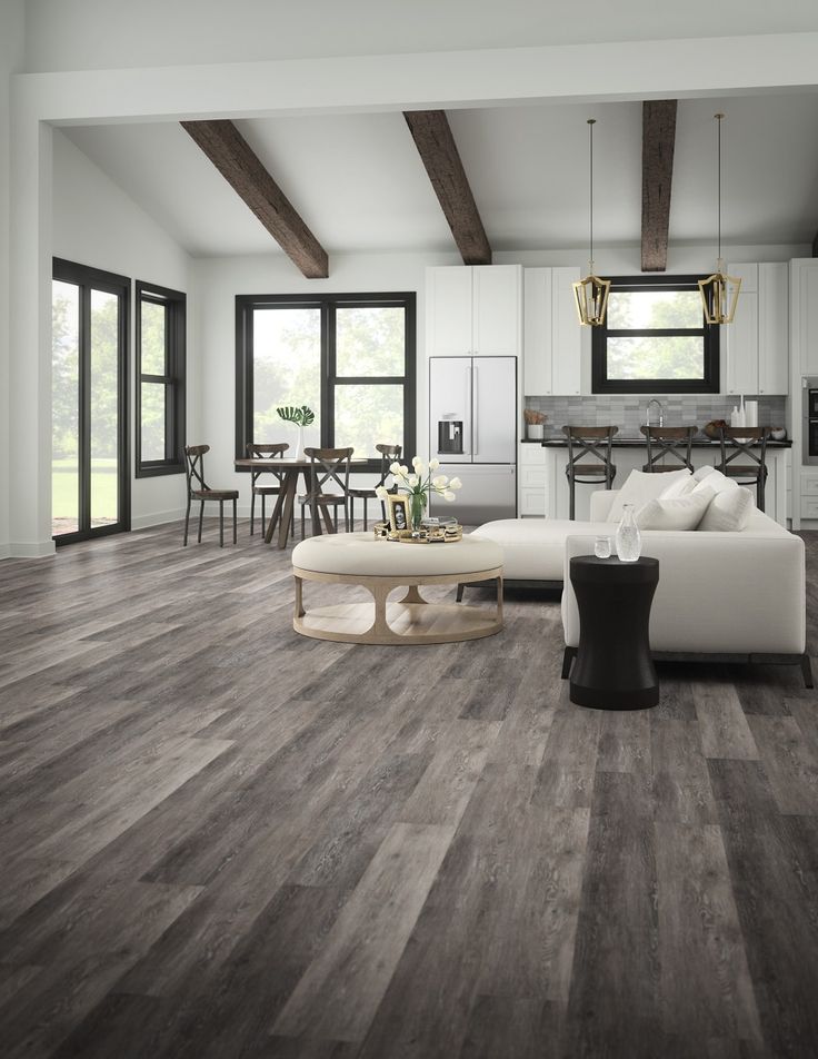 a living room with wood floors and white furniture