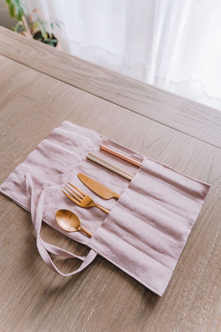 a pink bag with utensils and spoons on it