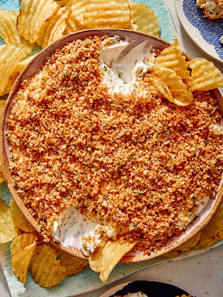 an image of a pie with chips on the side and other food items around it