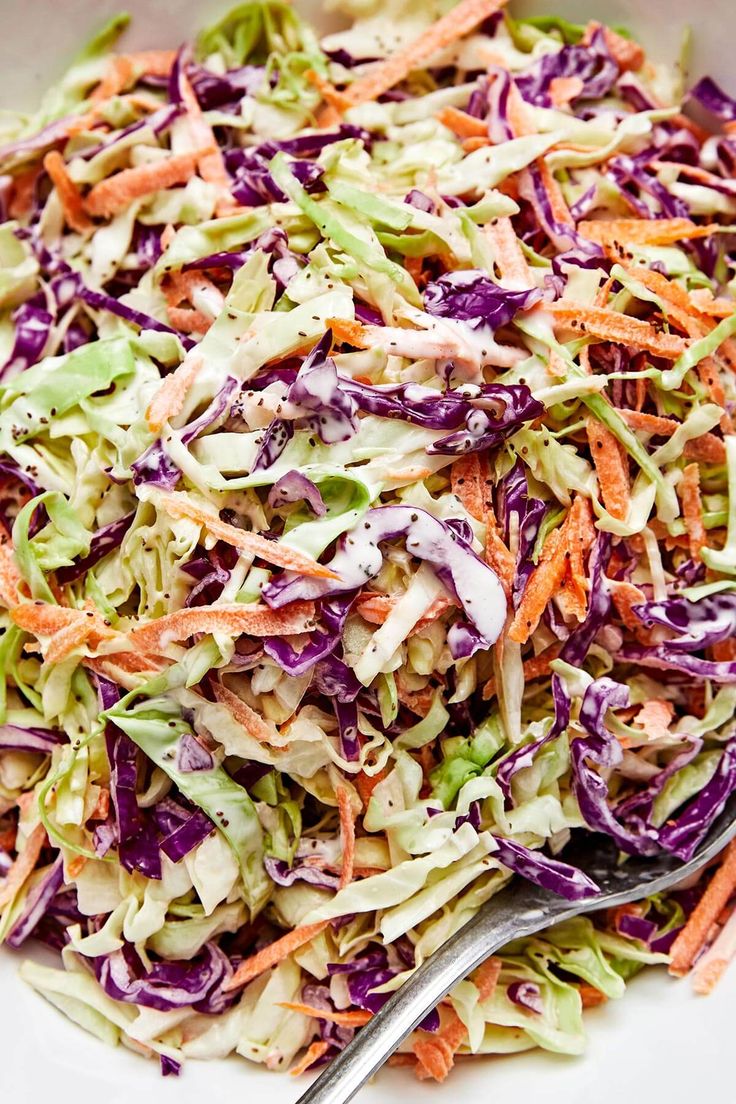 a white bowl filled with coleslaw and carrots