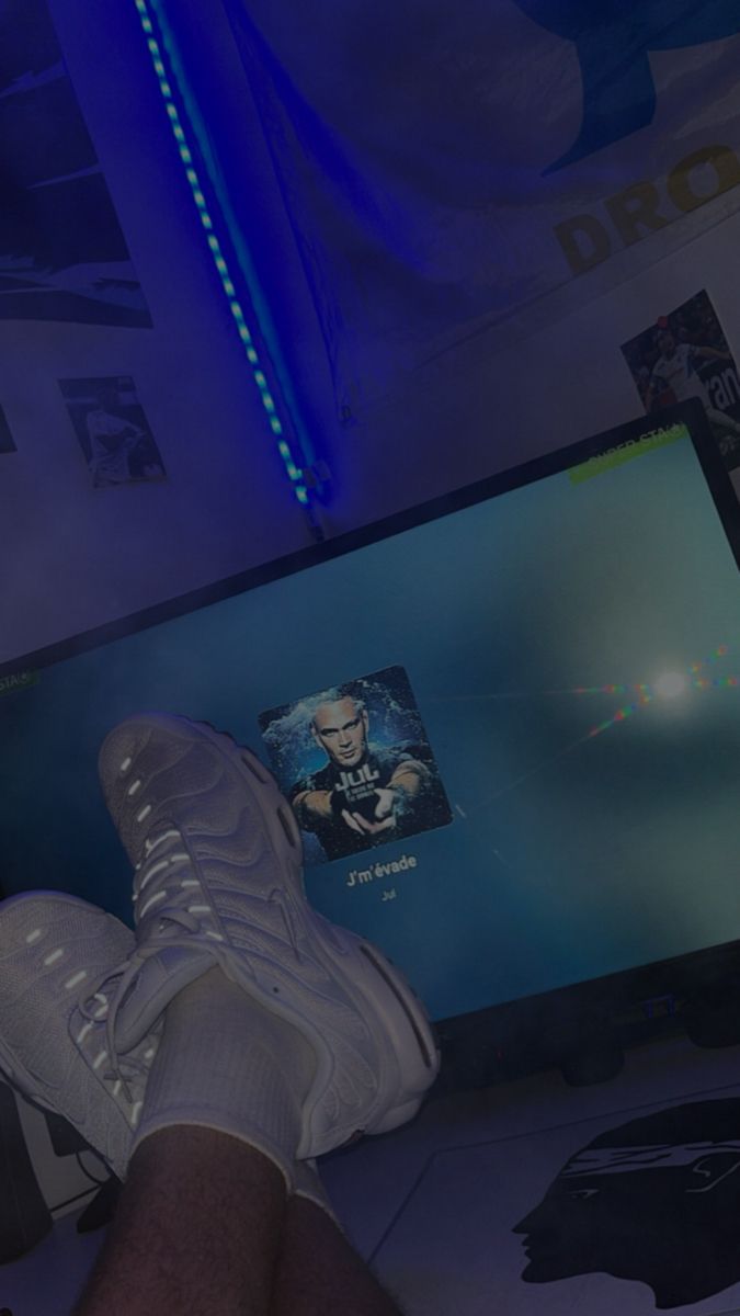 a person sitting in front of a tv with their feet propped up on the screen