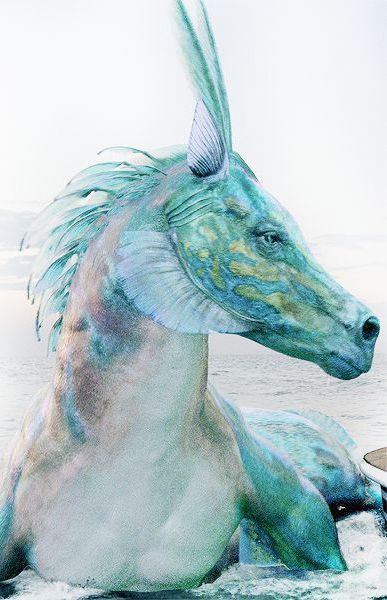 a blue and white horse statue sitting on top of a beach next to the ocean