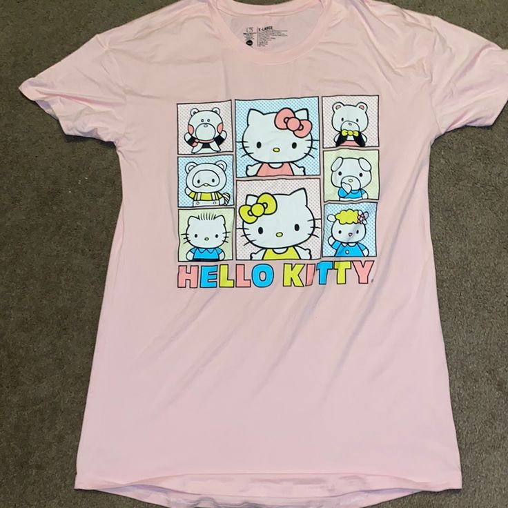 a hello kitty t - shirt is laying on the floor