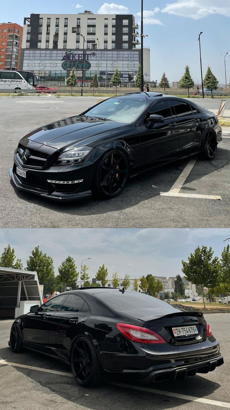 two black cars parked next to each other in a parking lot