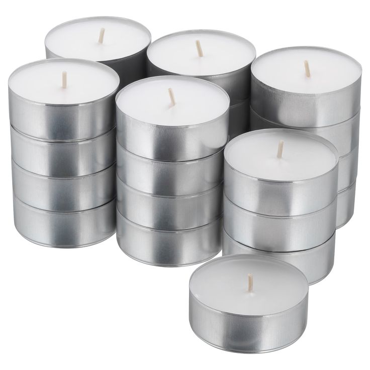 many silver candles are stacked on top of each other