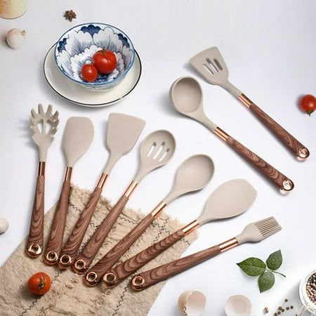 a bunch of utensils sitting on top of a table next to some tomatoes