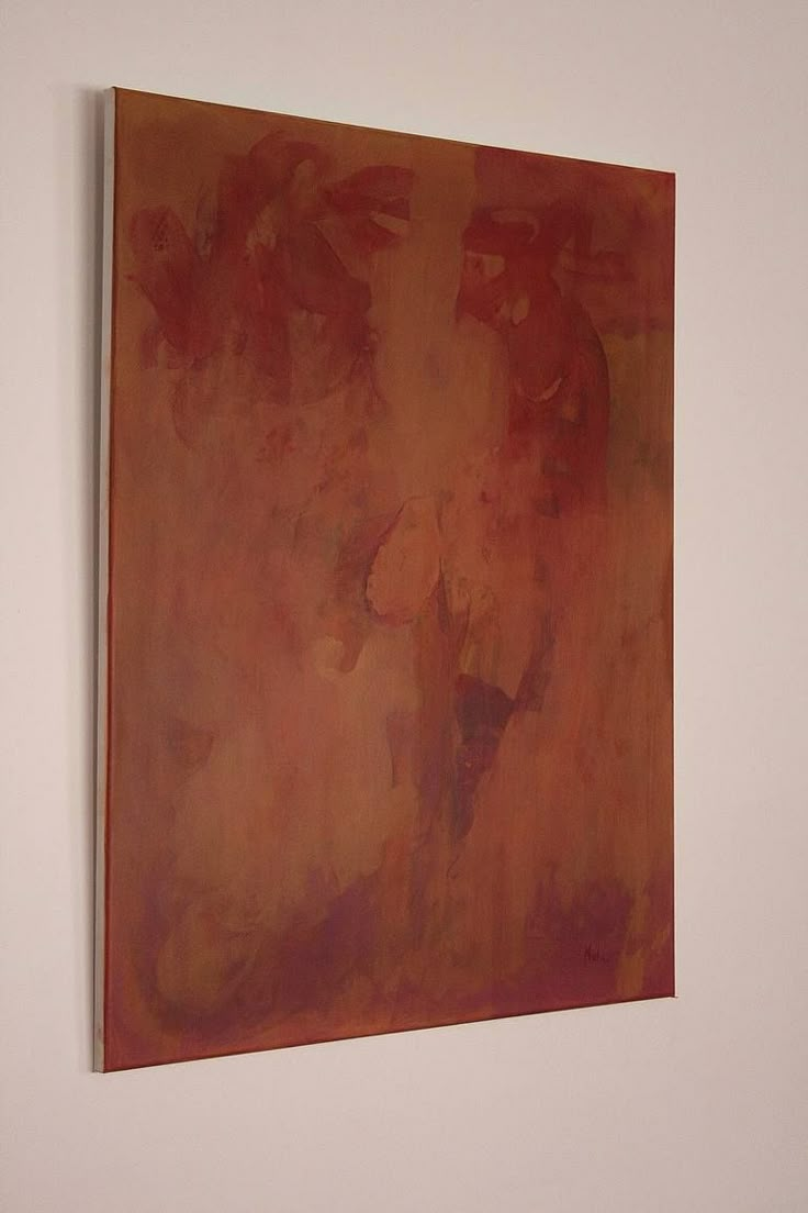 a painting hanging on the wall in an empty room