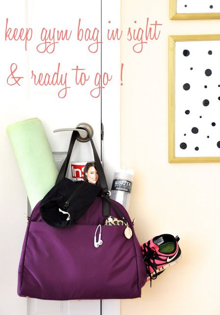 a purple bag hanging on the side of a door next to a pair of shoes