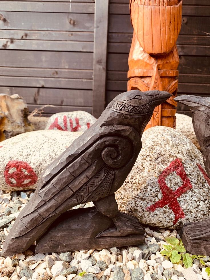 two carved birds sitting on top of rocks