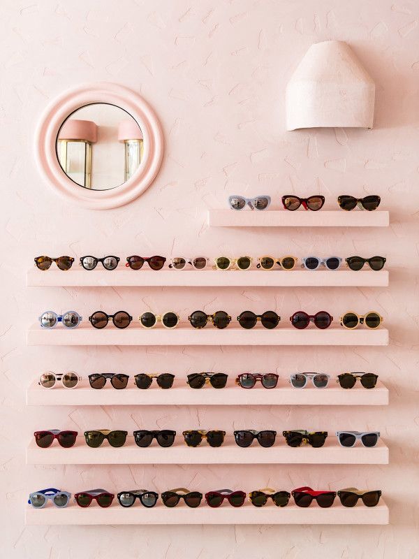 there are many pairs of sunglasses on the wall