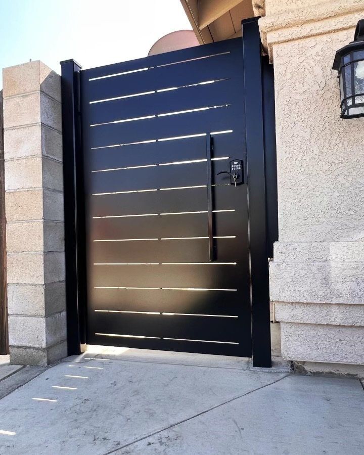 a large black door is open on the side of a building with a light hanging above it