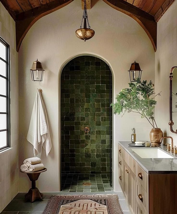 a bathroom with green tile and wooden ceiling