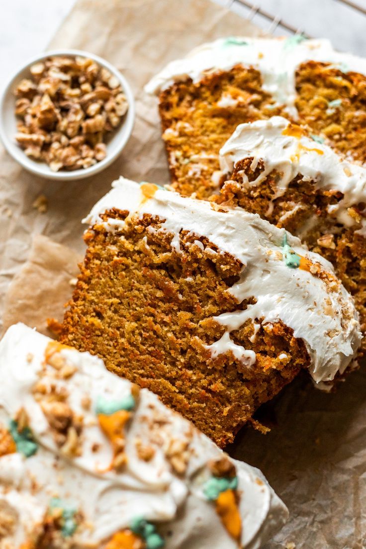 slices of carrot cake with white frosting and green sprinkles on top