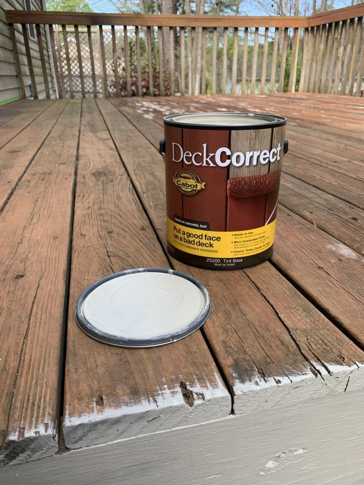 a paint can sitting on top of a wooden deck