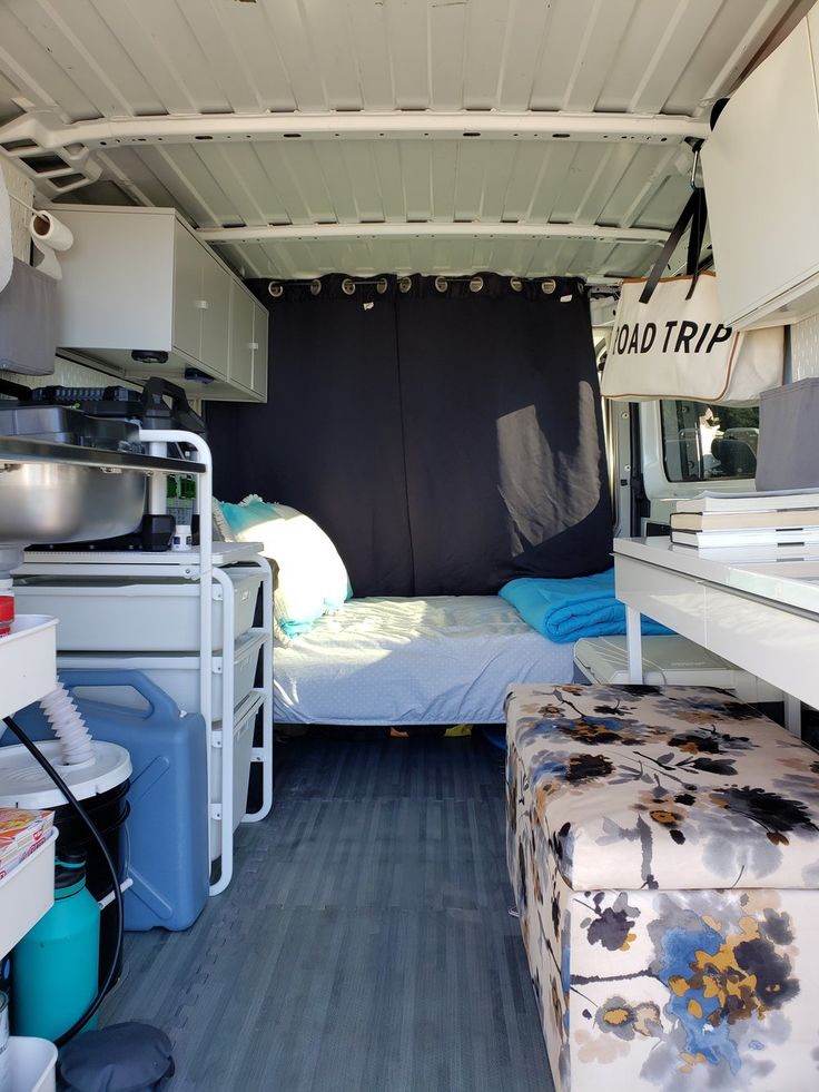 the inside of a camper with mattresses and storage