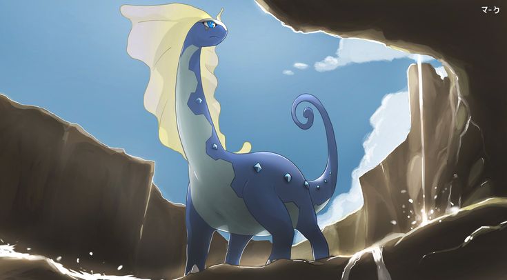 a blue and white dragon standing in the middle of a cave next to a mountain