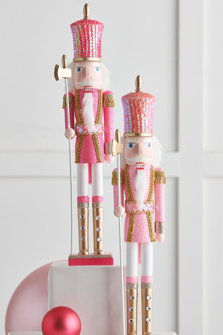 two nutcracker figurines are sitting on a table